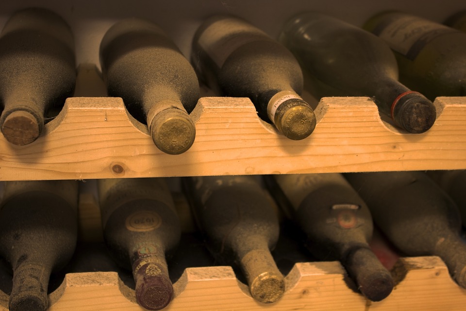 Old bottles of red wine in storage.