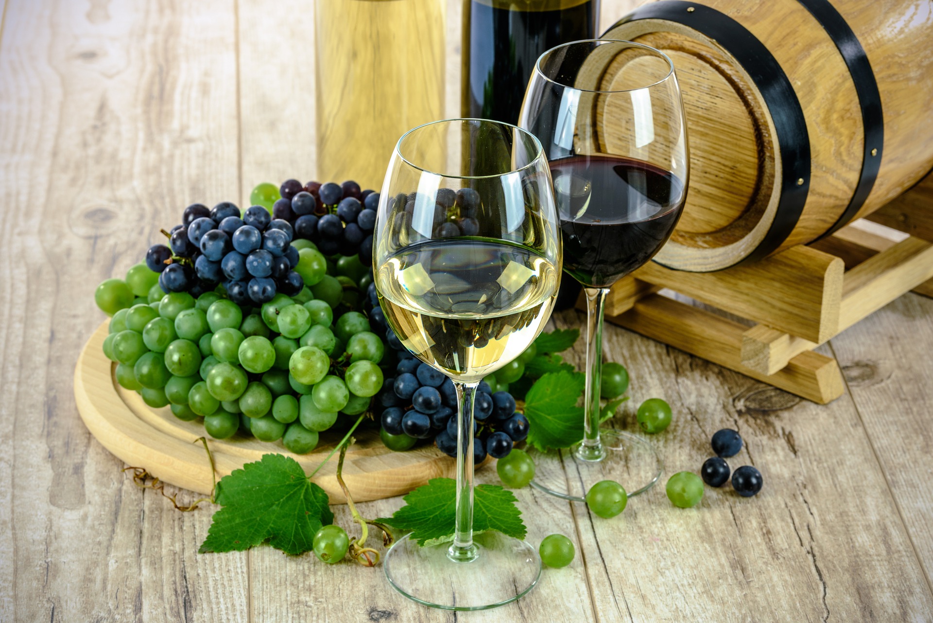 Grapes, fermenting barrel and wines ready to enjoy.